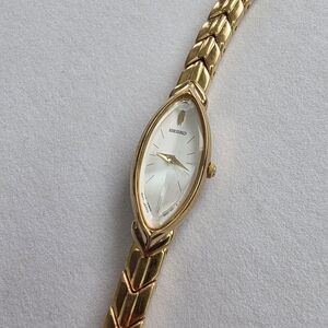 Seiko Women's Gold and White Watch